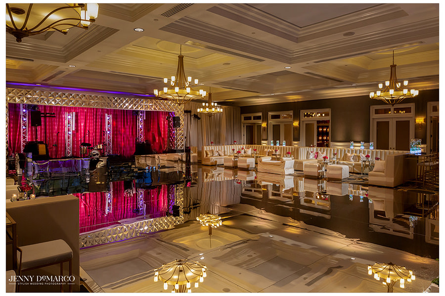 The ballroom at the reception space is decorated extravagantly with pink and white tones. 