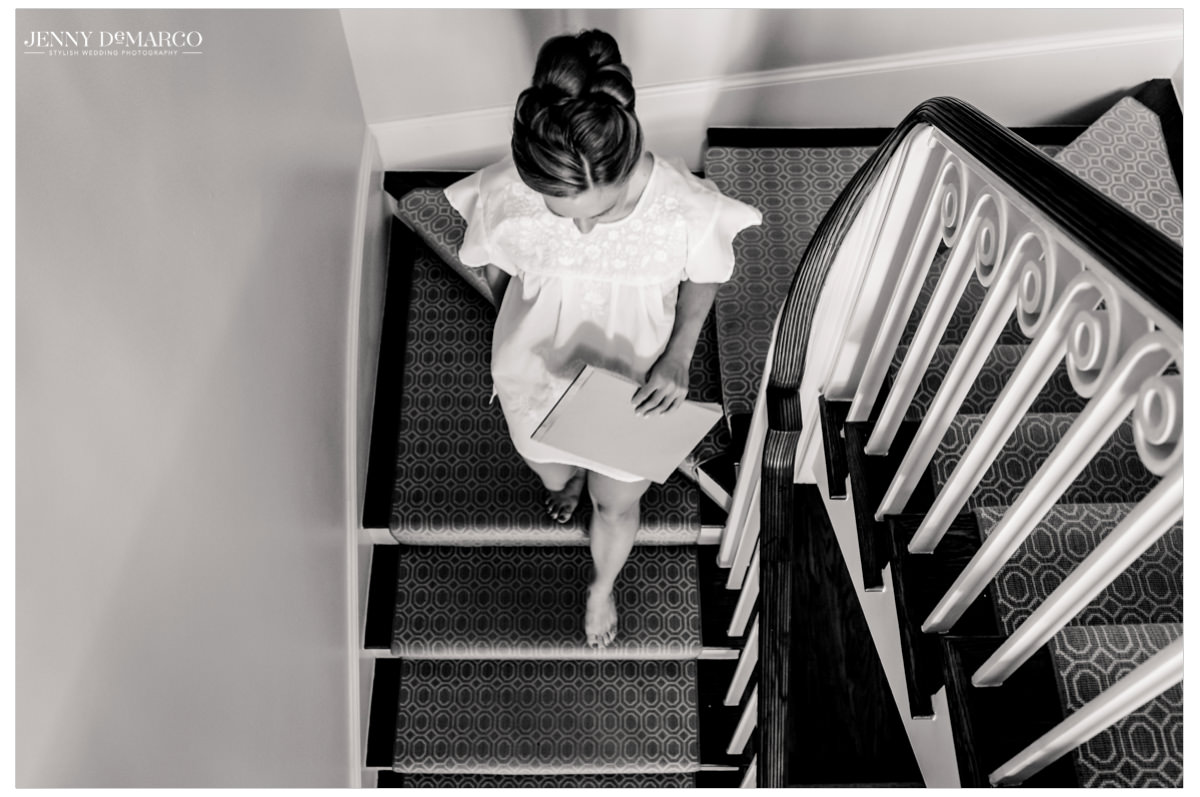 Bride walks down the stairs to hang out a gift.